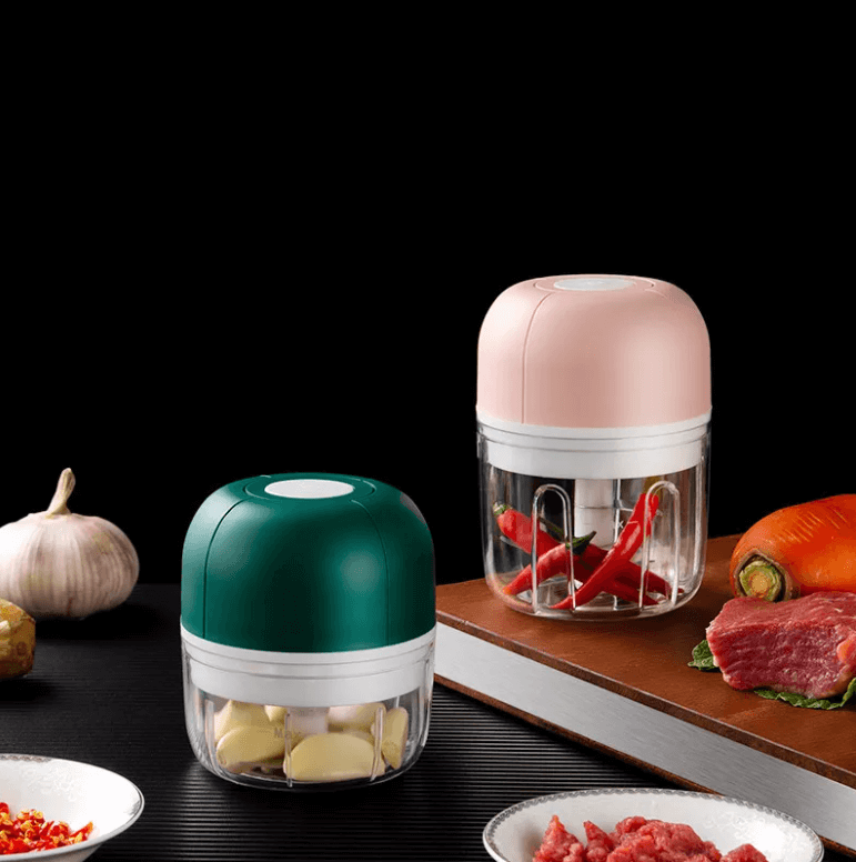 Portable electric garlic press & vegetable mincer, perfect for small batches. Rechargeable kitchen gadget.