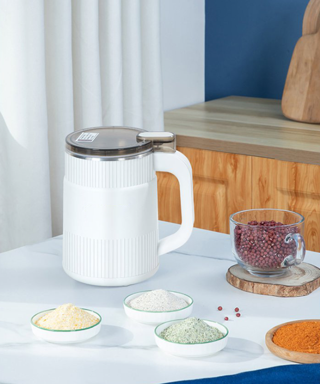 Electric grain mill actively grinding whole grains into fine, fresh flour for home baking recipes.