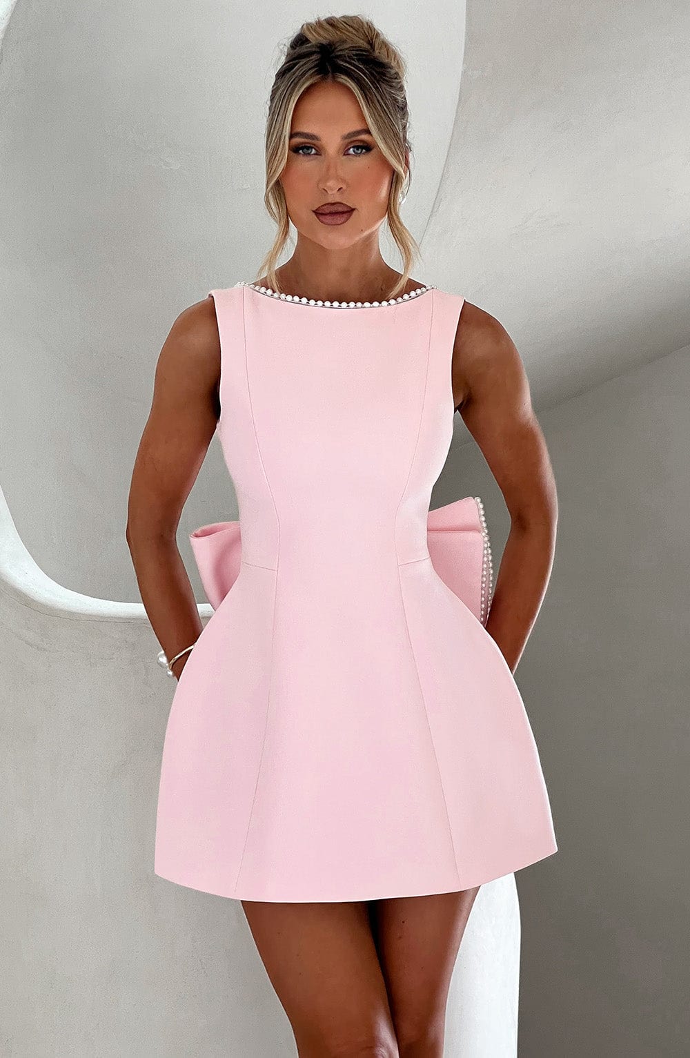 Elegant A-line homecoming mini dress for women with delicate pearl trim and a chic bow accent.