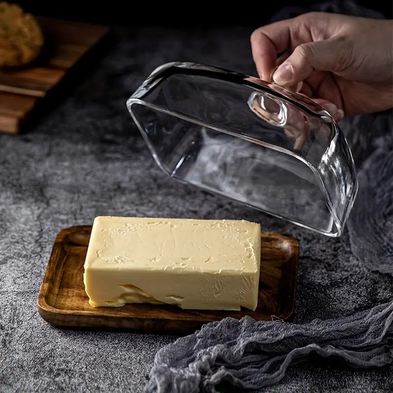 Beautiful wood butter holder with glass lid, an elegant kitchen accessory for serving & countertop display.