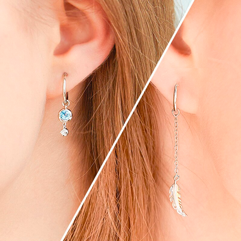 Unique asymmetric feather & moonstone dangle earrings in sterling silver. Elegant women's jewelry.