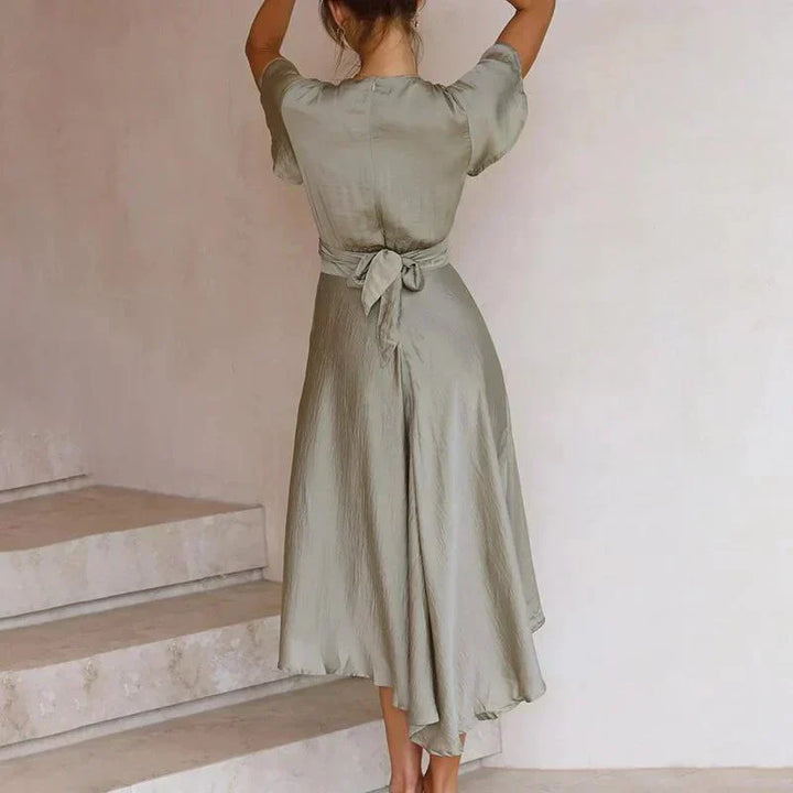 Women's elegant Aurora flowing retro summer dress in olive. Versatile midi length for vacation, beach, or casual wear.