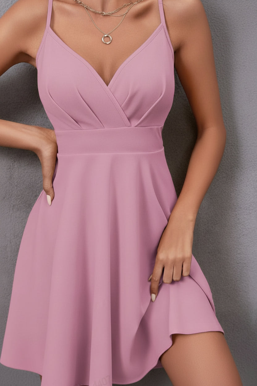 Flared women's summer party dress; backless with elegant cross straps. Perfect for cocktails and evening wear.