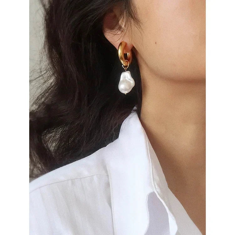 Women's fashion gold drop earrings with unique baroque pearls. Elegant and hypoallergenic retro jewelry.