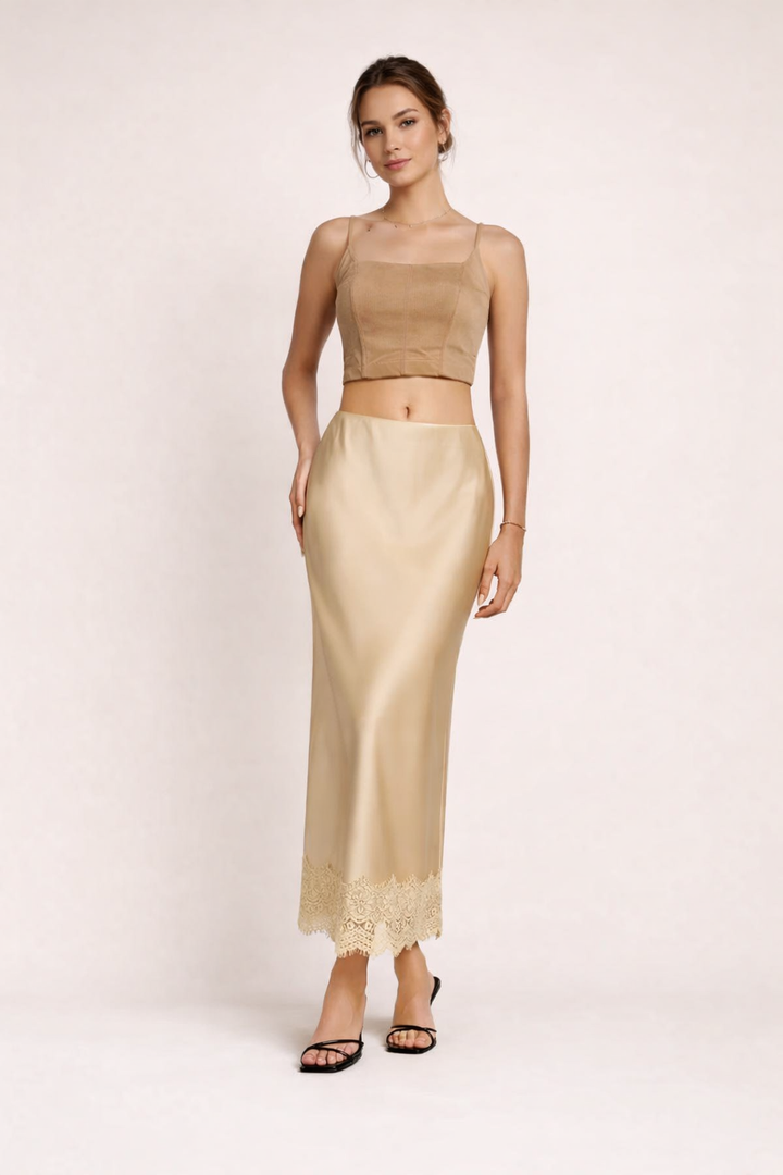 Elegant beige maxi skirt with delicate lace hem, perfect for formal events & evening wear.