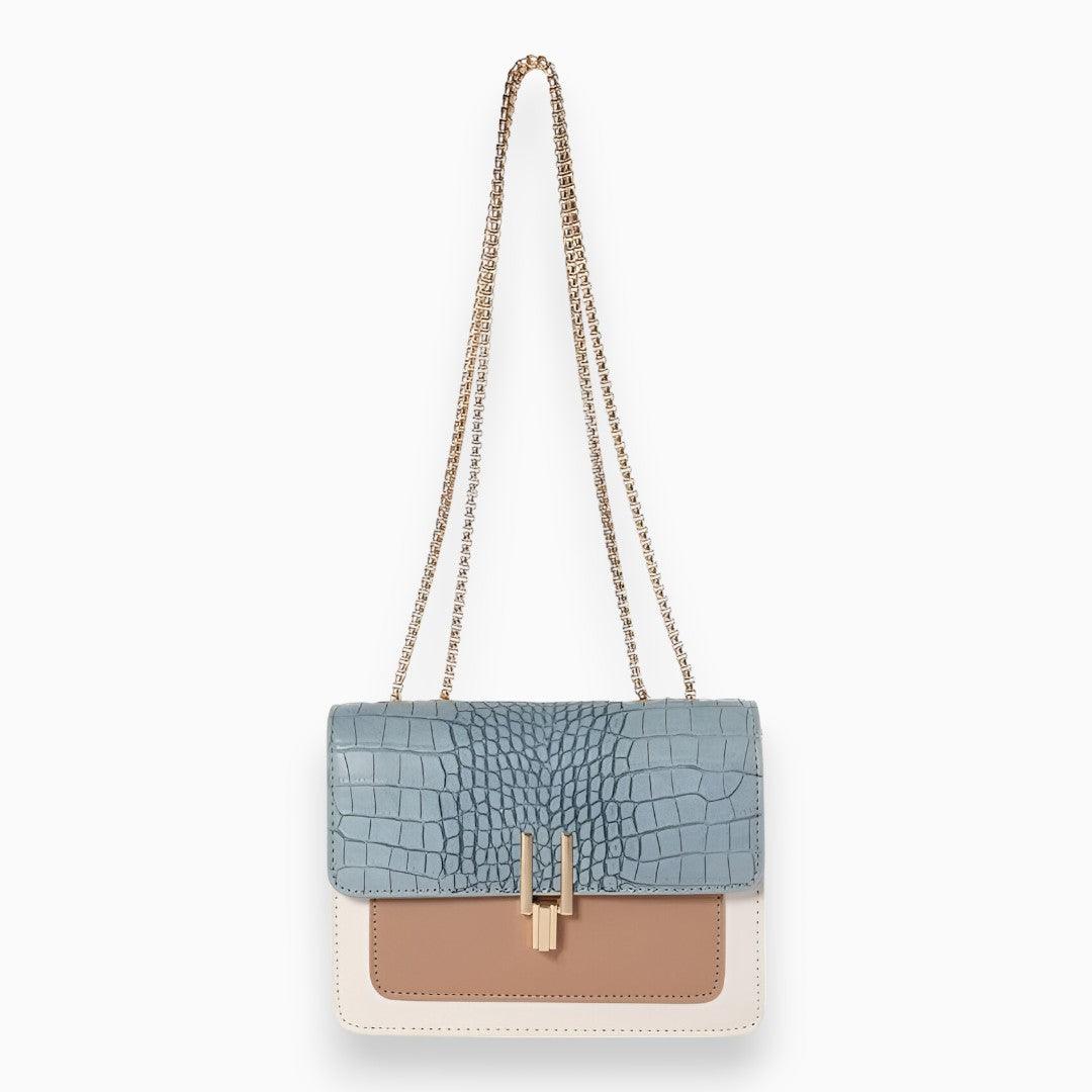 Elegant black faux leather flap shoulder bag for women, featuring a minimalist design and adjustable strap for crossbody wear.