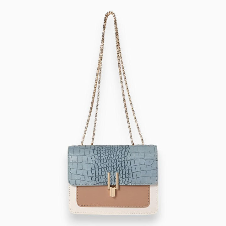 Elegant black faux leather flap shoulder bag for women, featuring a minimalist design and adjustable strap for crossbody wear.