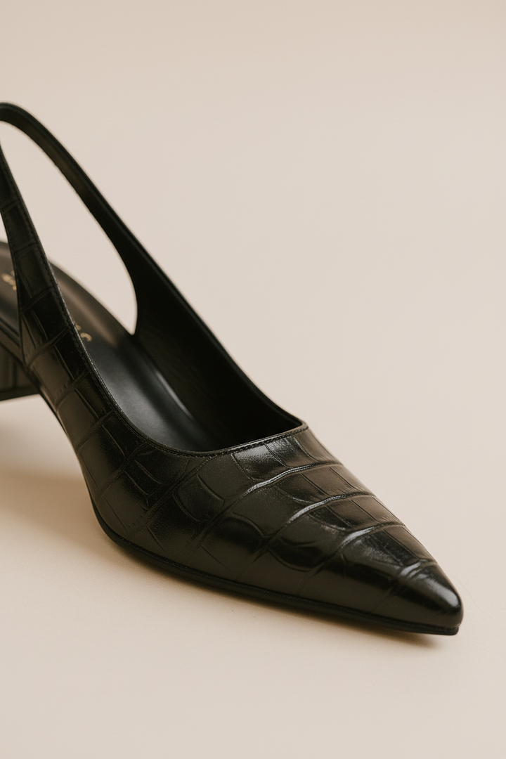 Close-up of the elegant slingback strap and stable low block heel on women's dress shoes