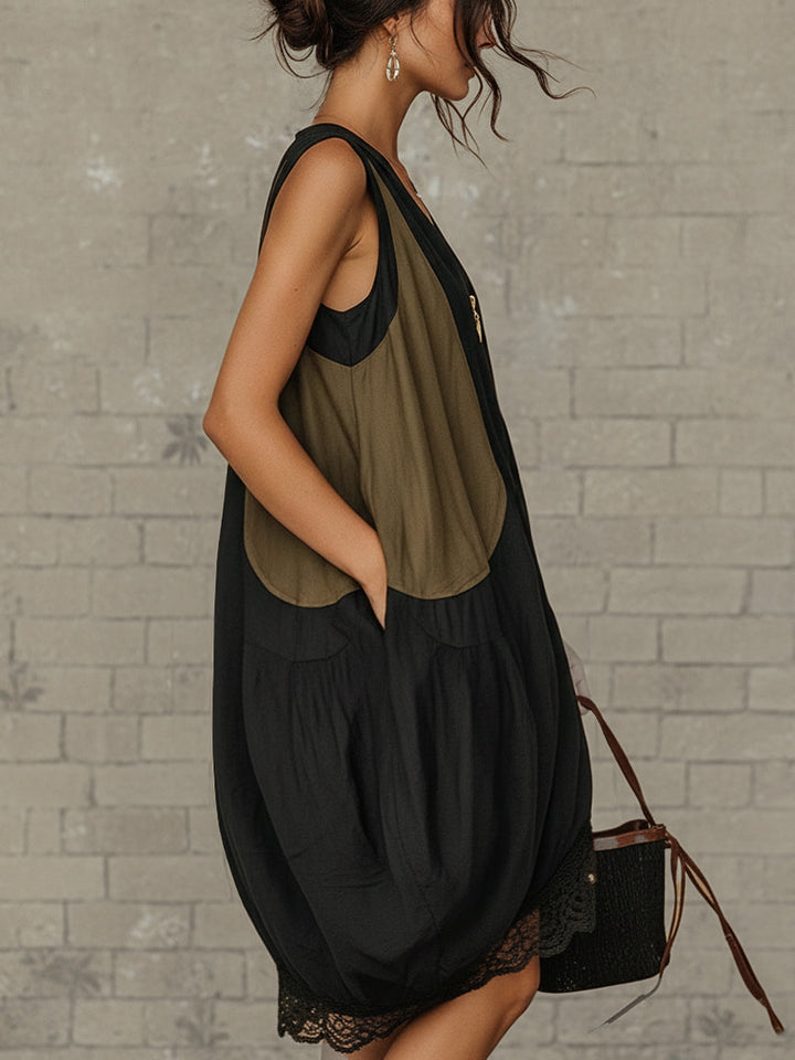 Close-up of the delicate lace hem detailing on a women's black midi dress, adding an elegant touch to the casual design.