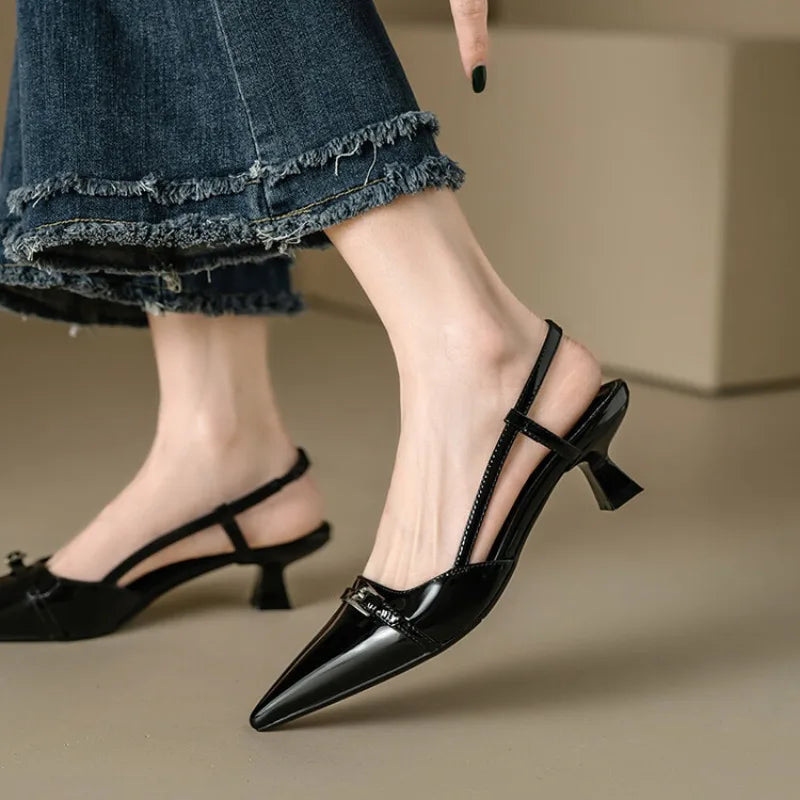 Classic black pointed toe kitten heels for women, a comfortable and elegant slingback style shoe.