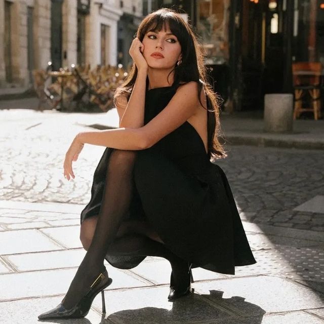 Black satin cocktail dress with a graceful flared cut, offering a chic look for evening events.