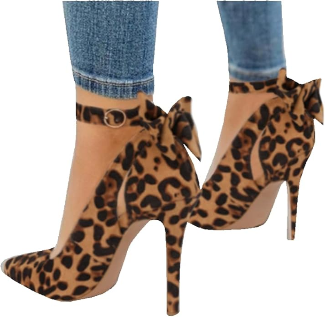 Close-up of a women's stiletto heel showing the pointed toe and intricate ankle bow detail.