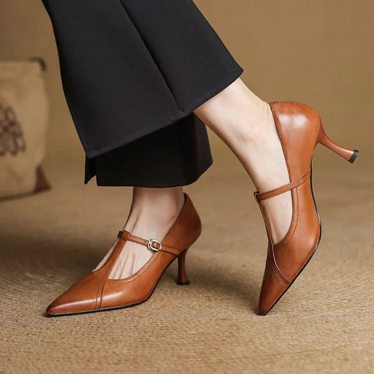 Elegant black T-strap mid-heel shoes for women, perfect for formal and evening wear.
