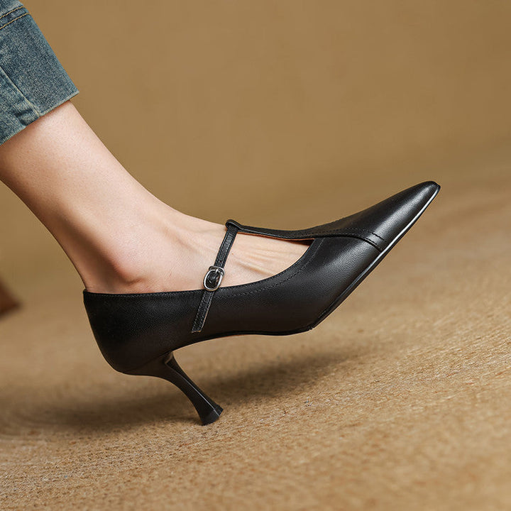Detail of the elegant T-strap and buckle on women's chic mid-heel formal shoes.