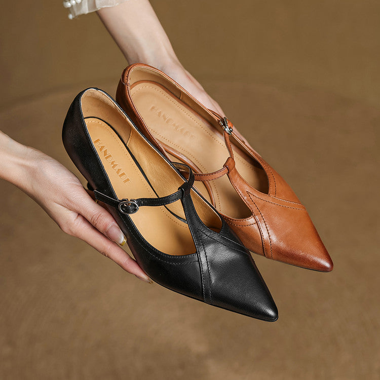 Profile view of elegant brown T-strap mid-heel shoes, showcasing the classic design.