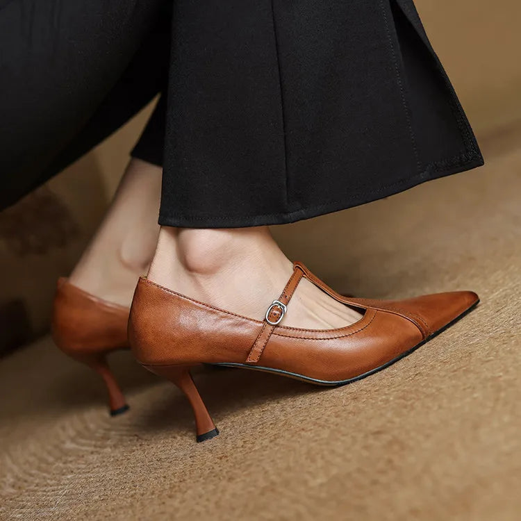 Classic black T-strap heels, offering comfortable mid-height for all-day elegance.