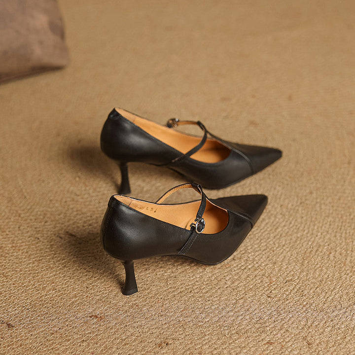 Classic black T-strap buckle heels, providing elegant style with comfortable mid-height.