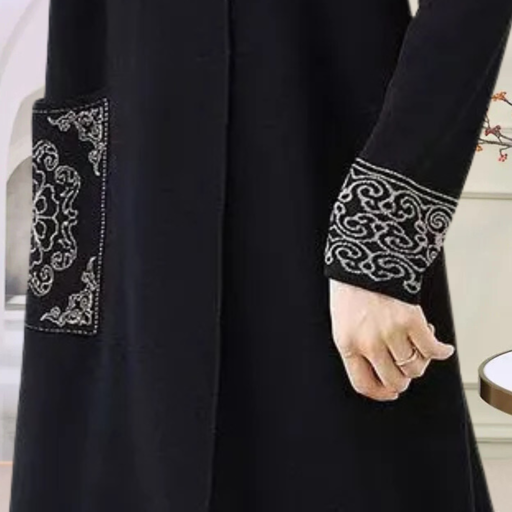 Warm black women's long sleeve knitted midi dress, ideal for elegant and comfortable winter fashion.