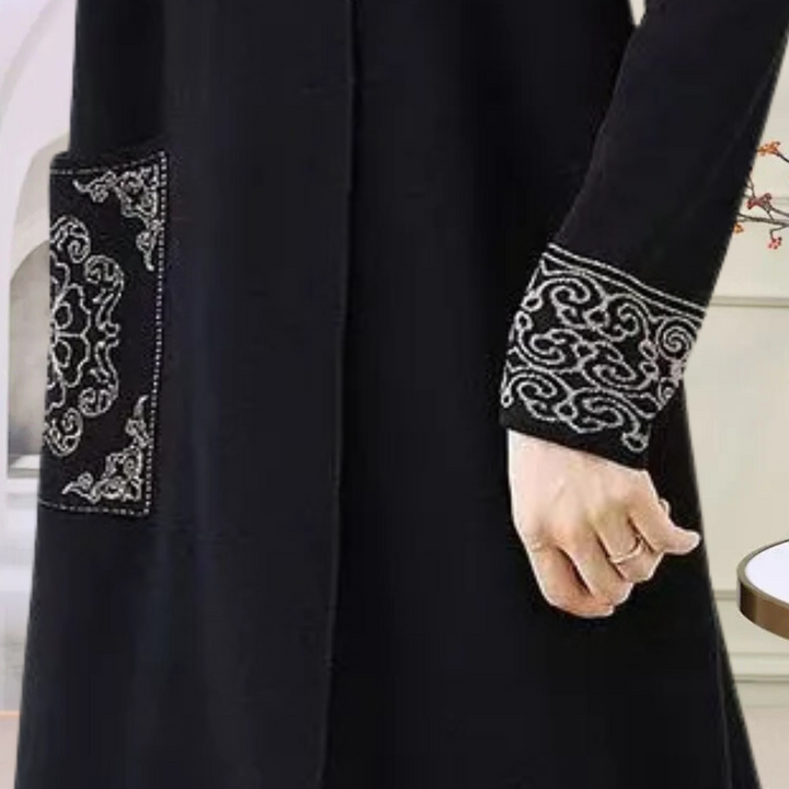 Warm black women's long sleeve knitted midi dress, ideal for elegant and comfortable winter fashion.