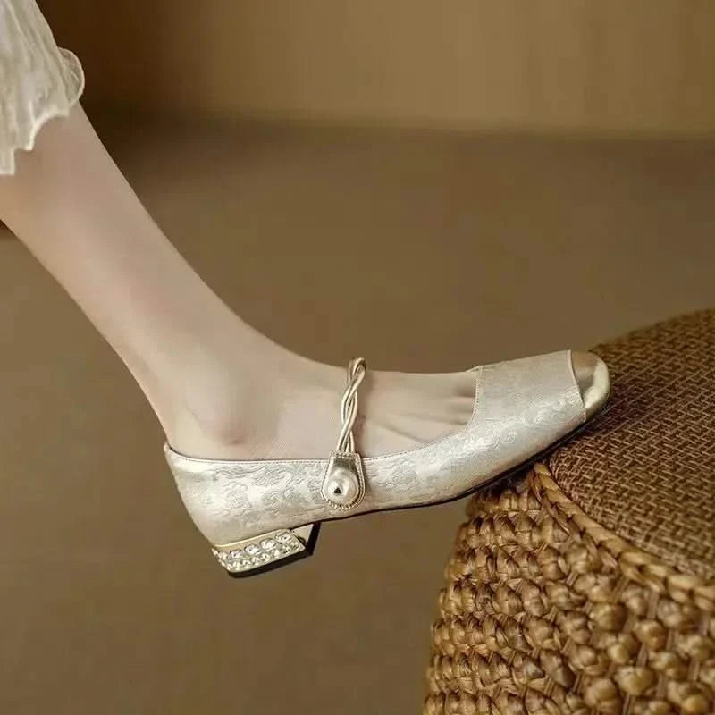 Side profile of women's square toe pumps, emphasizing the edgy studded heel and classic silhouette.