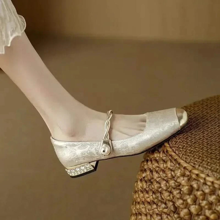 Side profile of women's square toe pumps, emphasizing the edgy studded heel and classic silhouette.