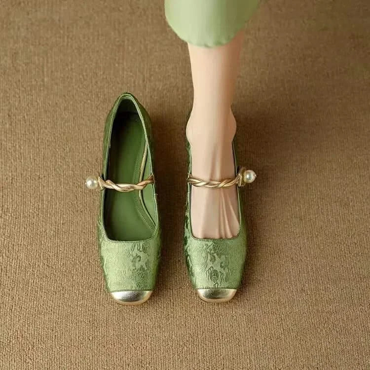 Close-up of a women's square toe pump, highlighting the detailed studded heel and refined craftsmanship.
