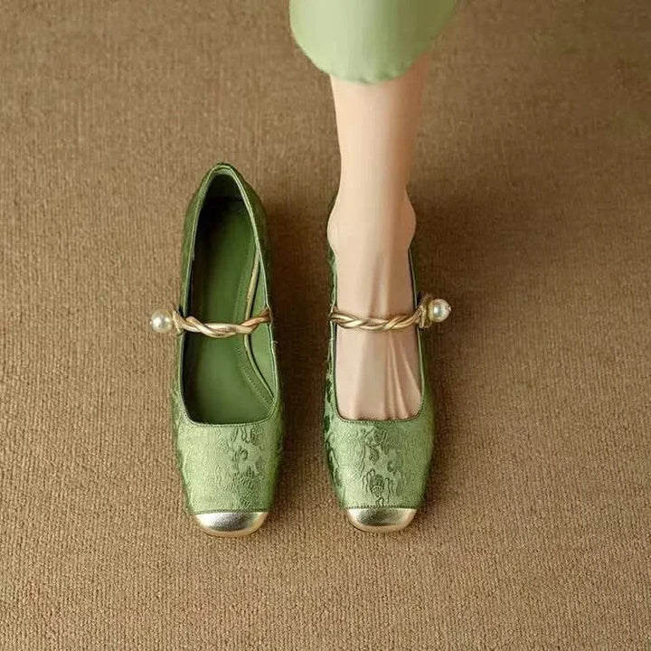 Close-up of a women's square toe pump, highlighting the detailed studded heel and refined craftsmanship.