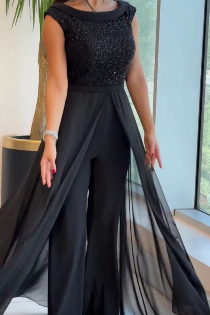 Versatile women's black textured jumpsuit with crew neck, perfect for elegant modern or casual wear.