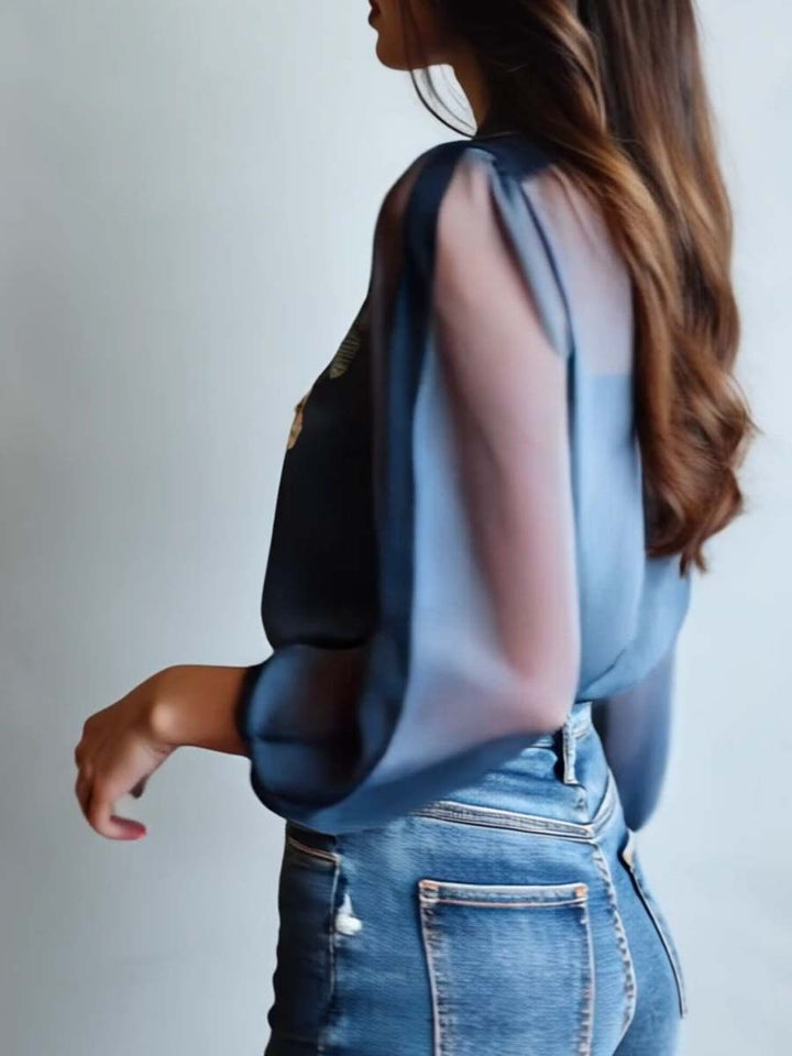 Women's blue floral top featuring intricate embroidery, sheer sleeves, and a flattering V-neck design.
