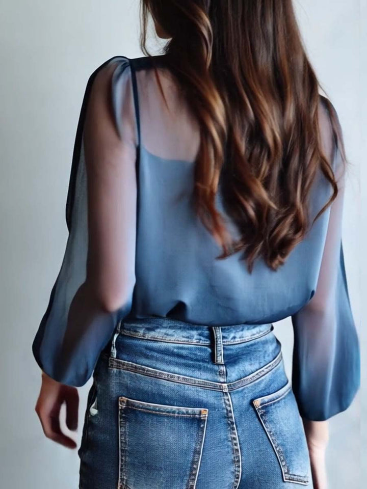 Feminine long-sleeve blue blouse with delicate floral embroidery & sheer sleeves, perfect for special occasions.
