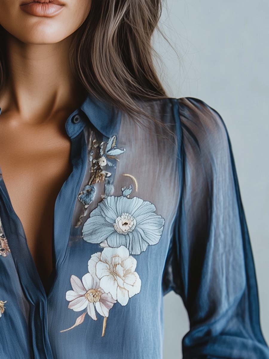 Versatile blue floral blouse for women, boasting elegant sheer sleeves, V-neck, and detailed embroidery.