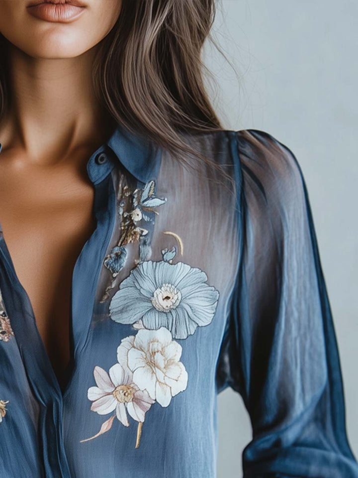 Versatile blue floral blouse for women, boasting elegant sheer sleeves, V-neck, and detailed embroidery.