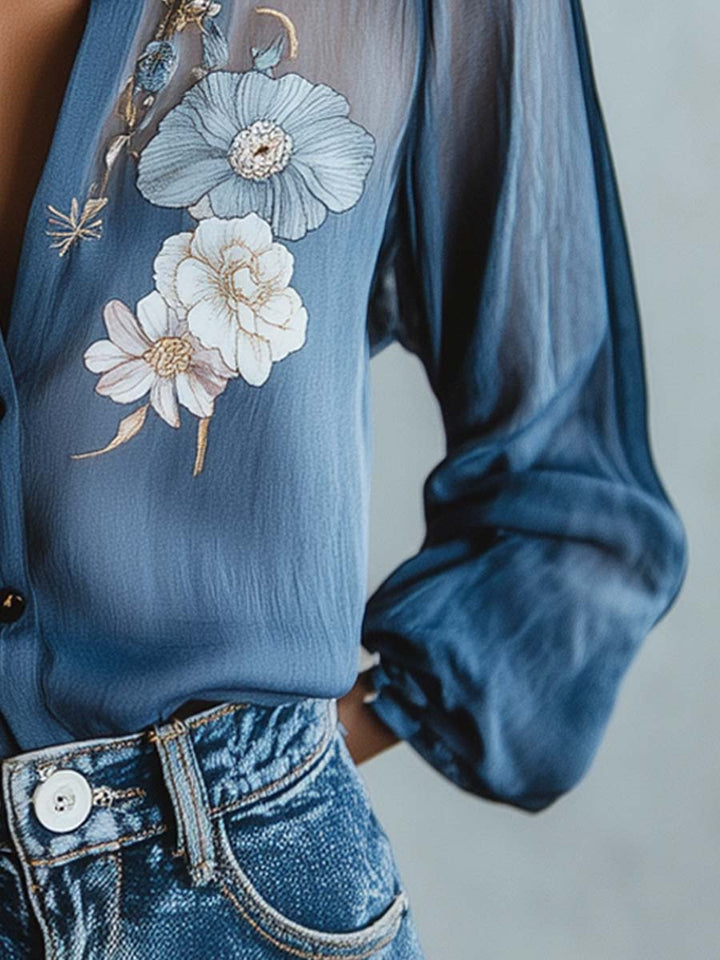 Chic blue women's blouse, featuring feminine floral embroidery, sheer sleeves, and a comfortable relaxed fit.