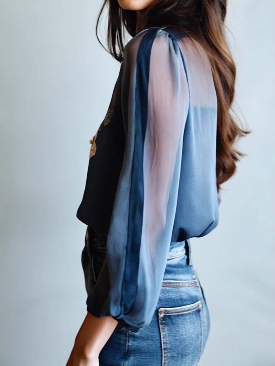 Detailed view of women's blue floral embroidered sheer sleeve blouse, a sophisticated and versatile V-neck.