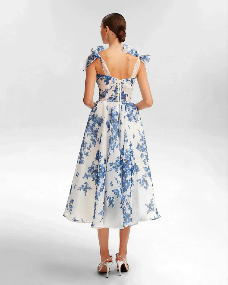 Stunning blue floral midi dress for women, featuring a flattering sweetheart neckline & elegant corset back. Summer fashion.