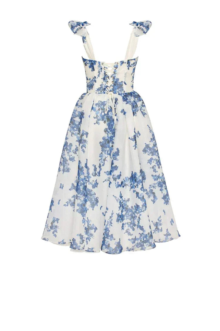 Chic blue floral midi dress with sweetheart neckline, corset back & tie straps. A beautiful choice for summer parties.