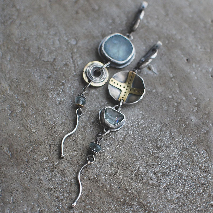 Women's blue stone cross dangle earrings, elegant spiritual jewelry. Ideal religious gift or fashion accessory.