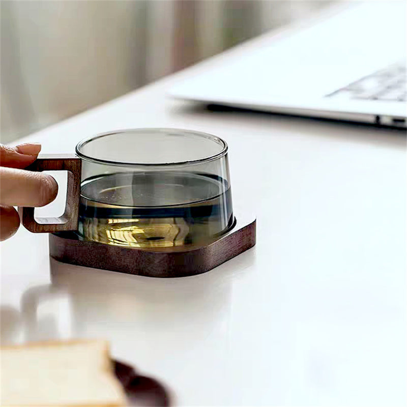 Clear glass coffee mug with comfortable cedar wood handle, ideal drinkware for hot or cold beverages.