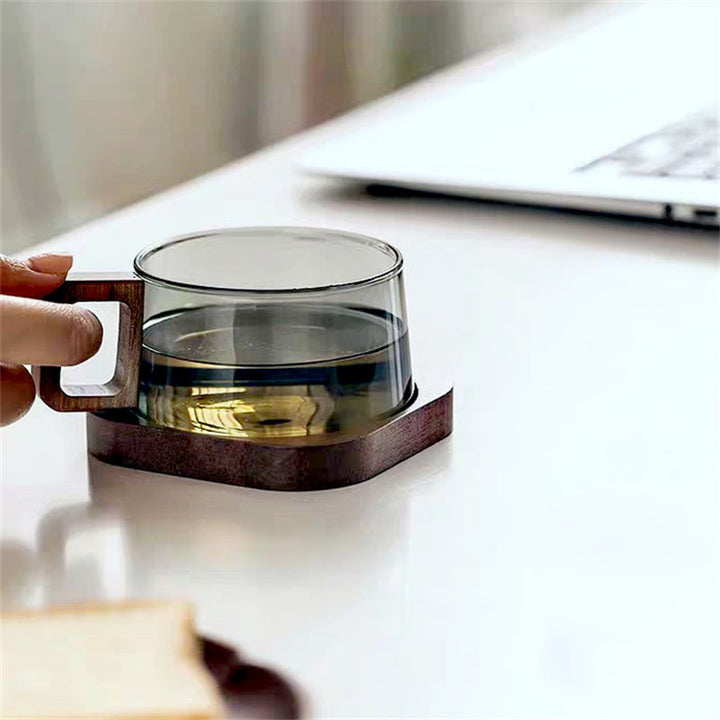 Clear glass coffee mug with comfortable cedar wood handle, ideal drinkware for hot or cold beverages.