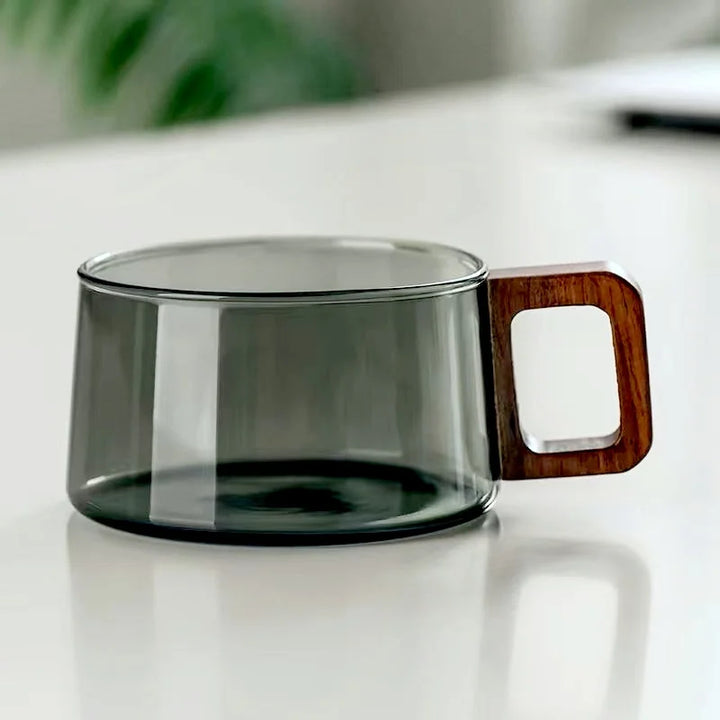 Stylish borosilicate glass tea cup featuring a unique cedar wood handle, a chic kitchenware addition.