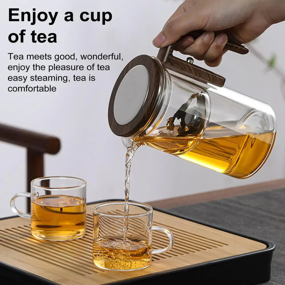Modern unisex glass teapot and tea maker with built-in infuser, showcasing brewing tea.