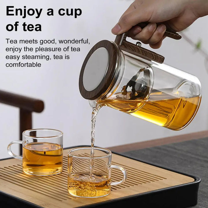 Modern unisex glass teapot and tea maker with built-in infuser, showcasing brewing tea.