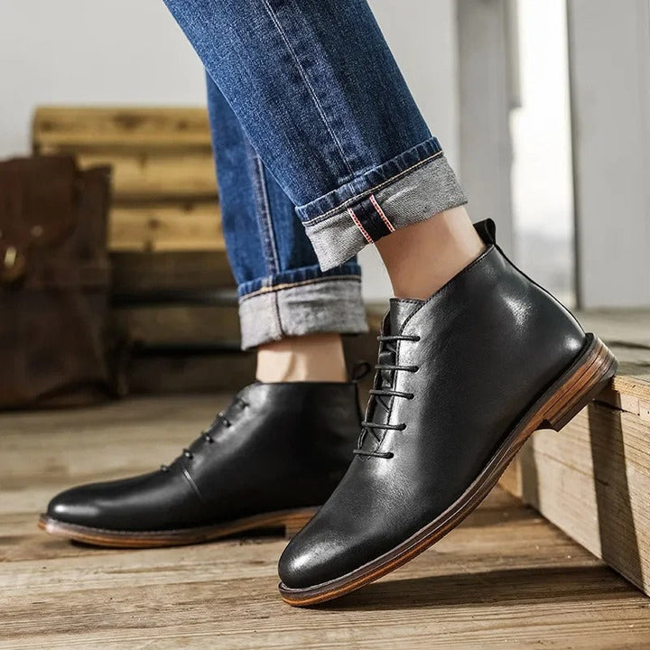 Back detail of men's durable leather ankle boots. Sturdy heel and construction for lasting comfort. Premium men's footwear.