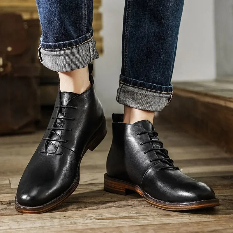 Men's black leather dress boots paired with professional attire. Ideal for business meetings & formal events. Comfortable.