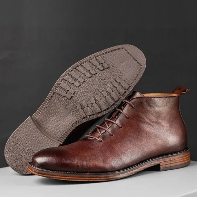 Stylish black leather men's dress boots on-foot, paired with a suit. Ideal for formal occasions & professional attire.