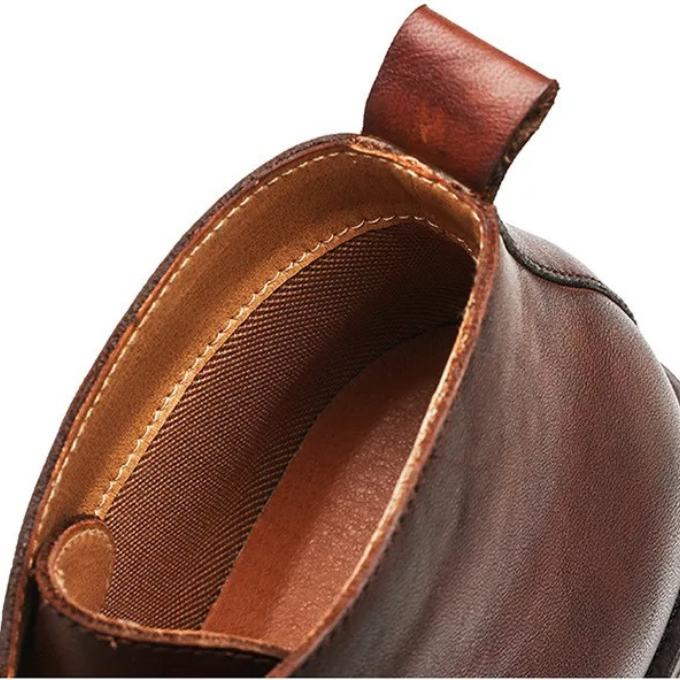Pair of men's versatile leather boots (one brown, one black), demonstrating style & color options for any look.