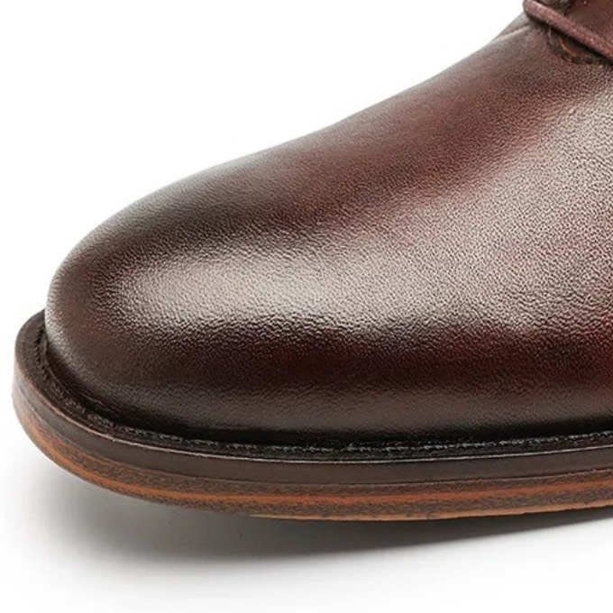 Durable sole of men's leather dress boot, providing comfort & traction. High-quality men's footwear for all-day wear.
