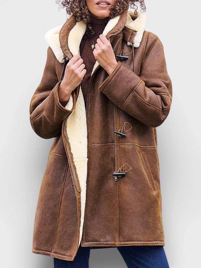 Elegant brown women's long winter coat, offering warm and sophisticated classic style for cold weather.