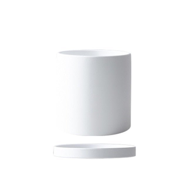 Minimalist ceramic pot with saucer, perfect for modern home interiors and plant enthusiasts.