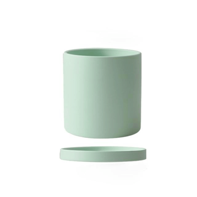 Modern round ceramic planter with saucer, perfect for tabletop or shelf plant displays.